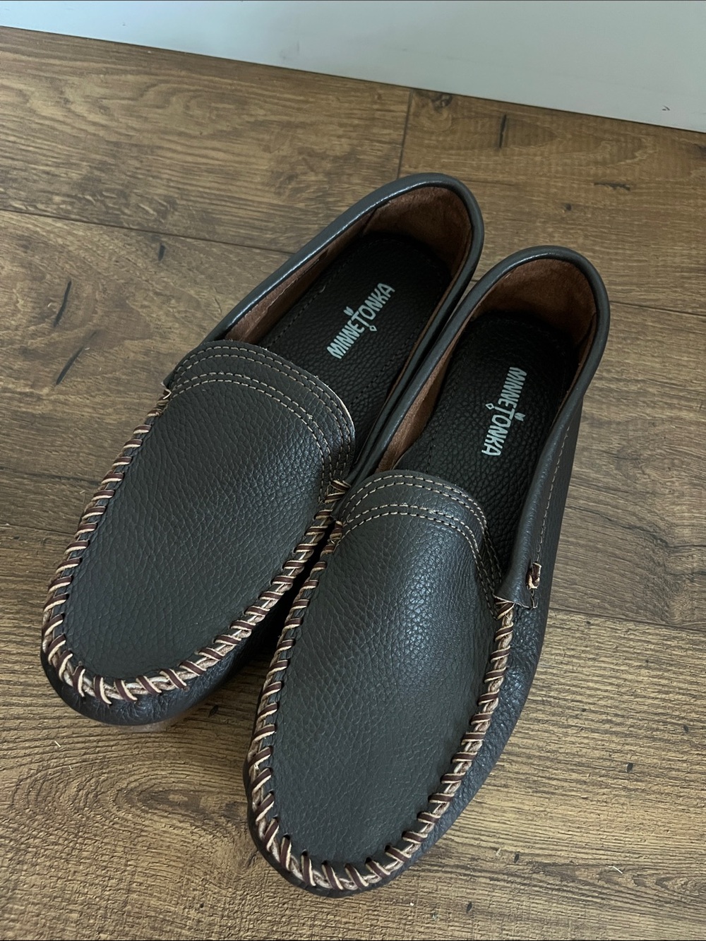 Minnetonka Men's Black Leather Slip-On Loafers with Brown Stitching